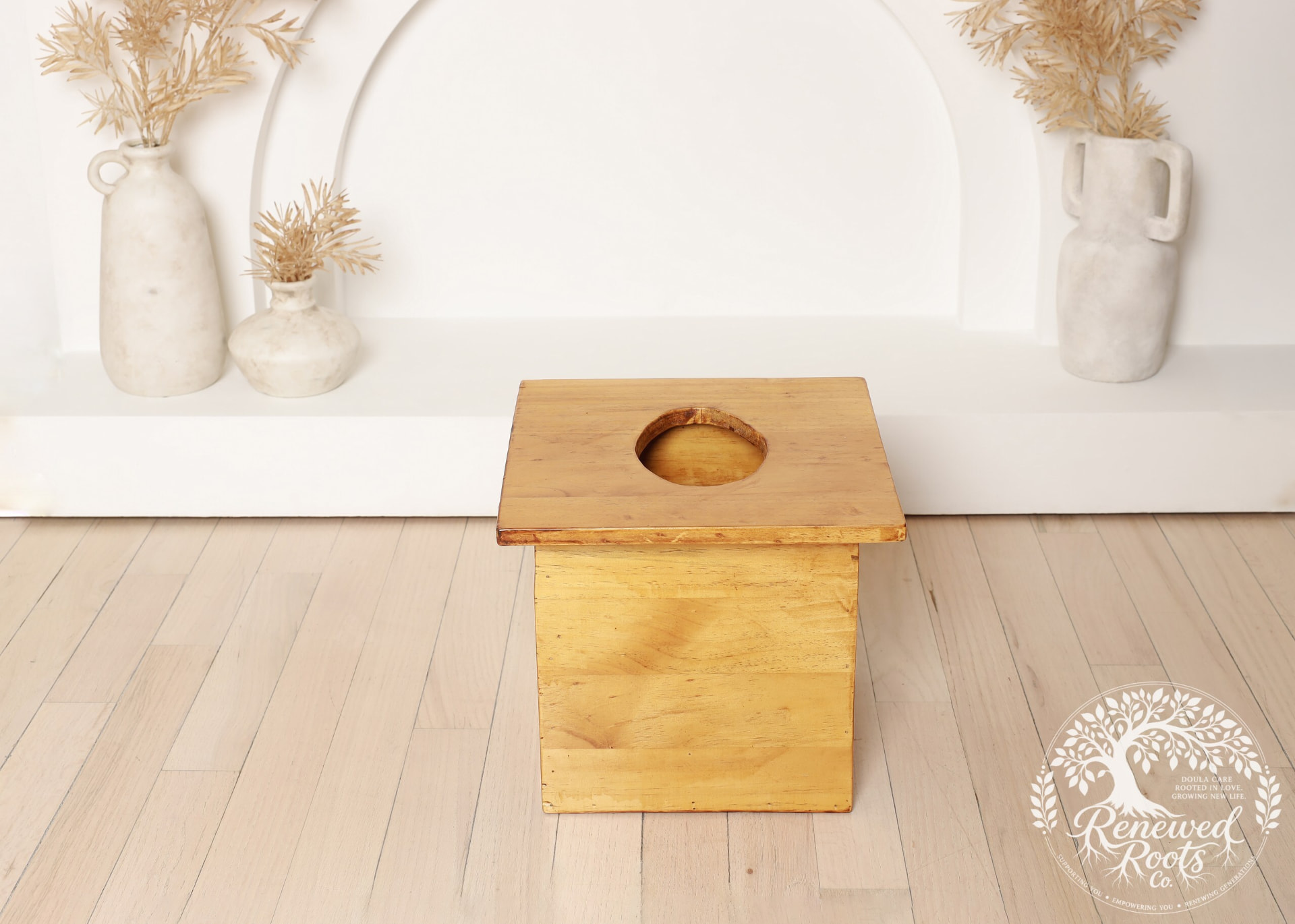 Wooden yoni steaming seat in a calm wellness setting